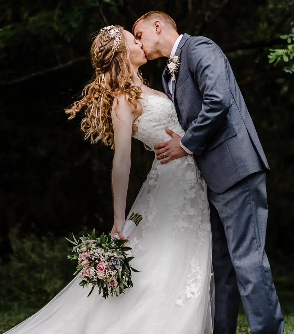 Couple wearing a white gown and grey suit