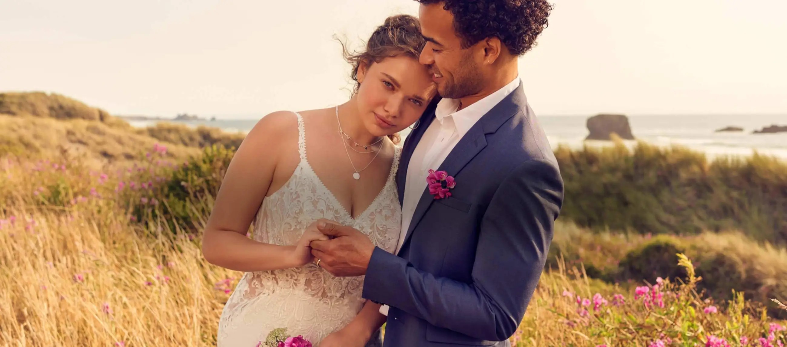 Couple wearing a white gown and grey suit