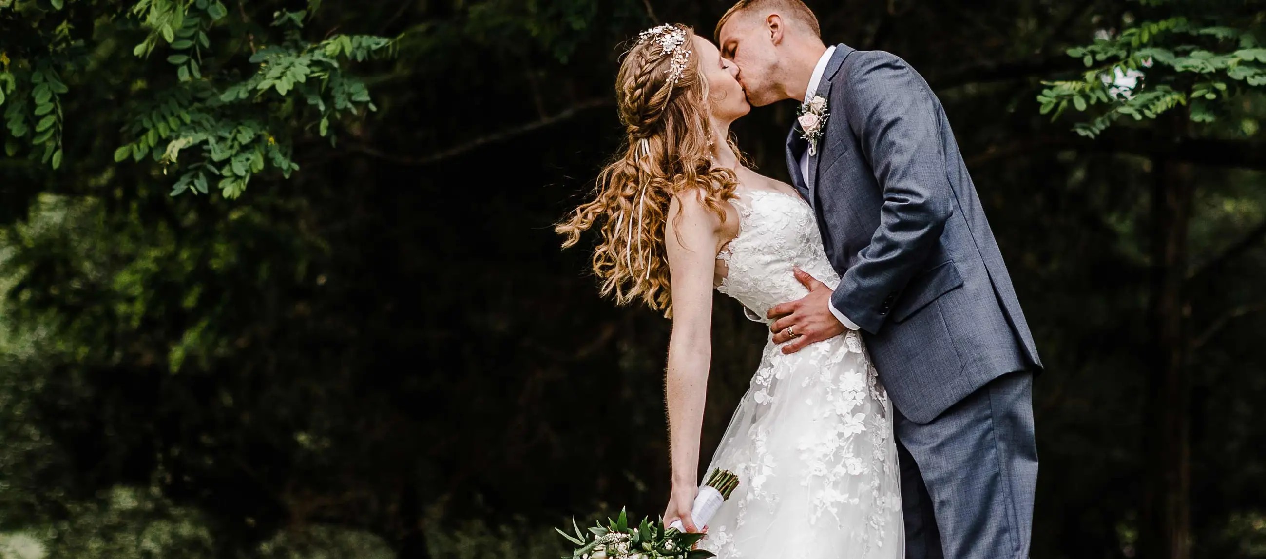Couple wearing a white gown and grey suit