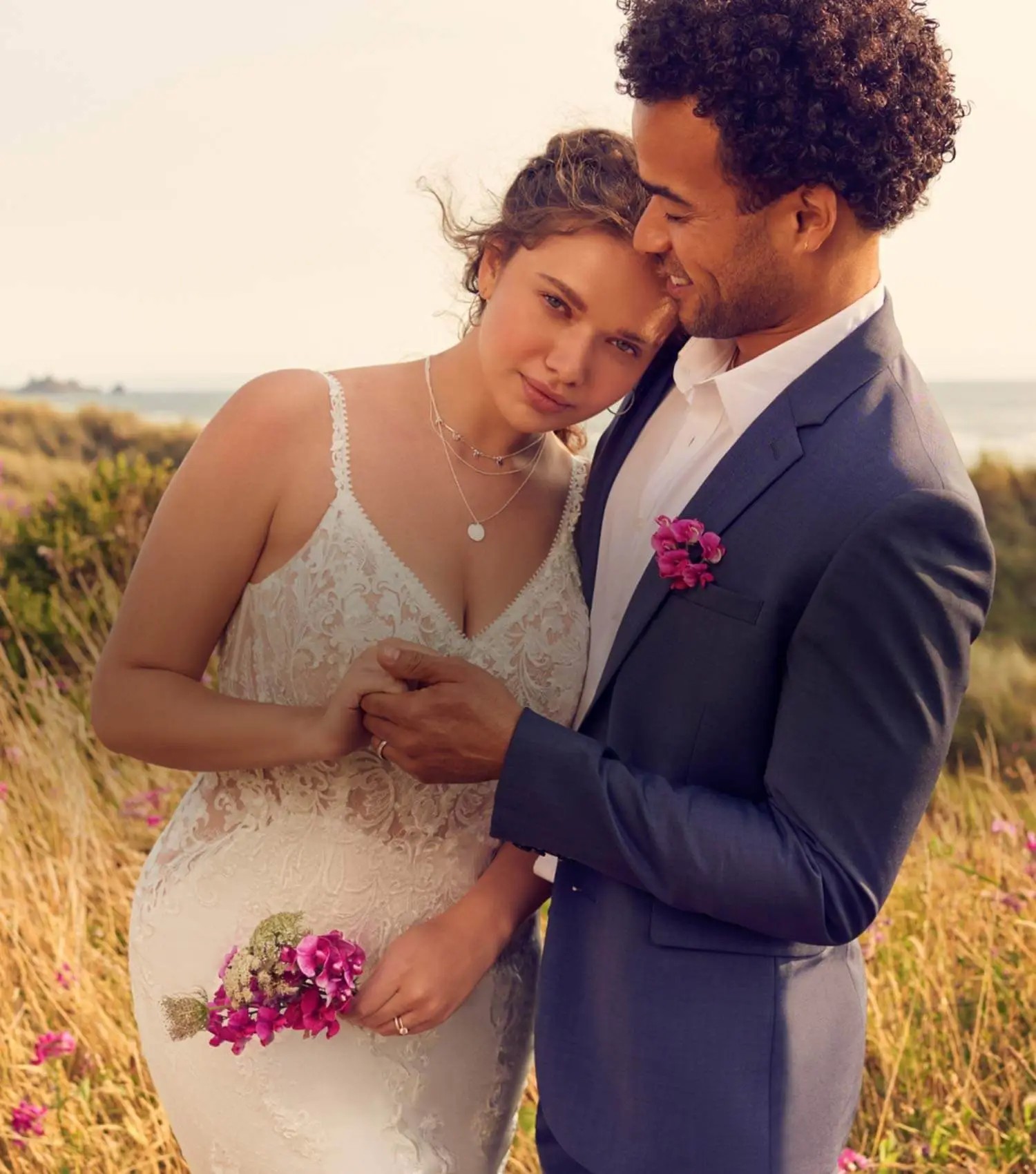 Couple wearing a white gown and grey suit